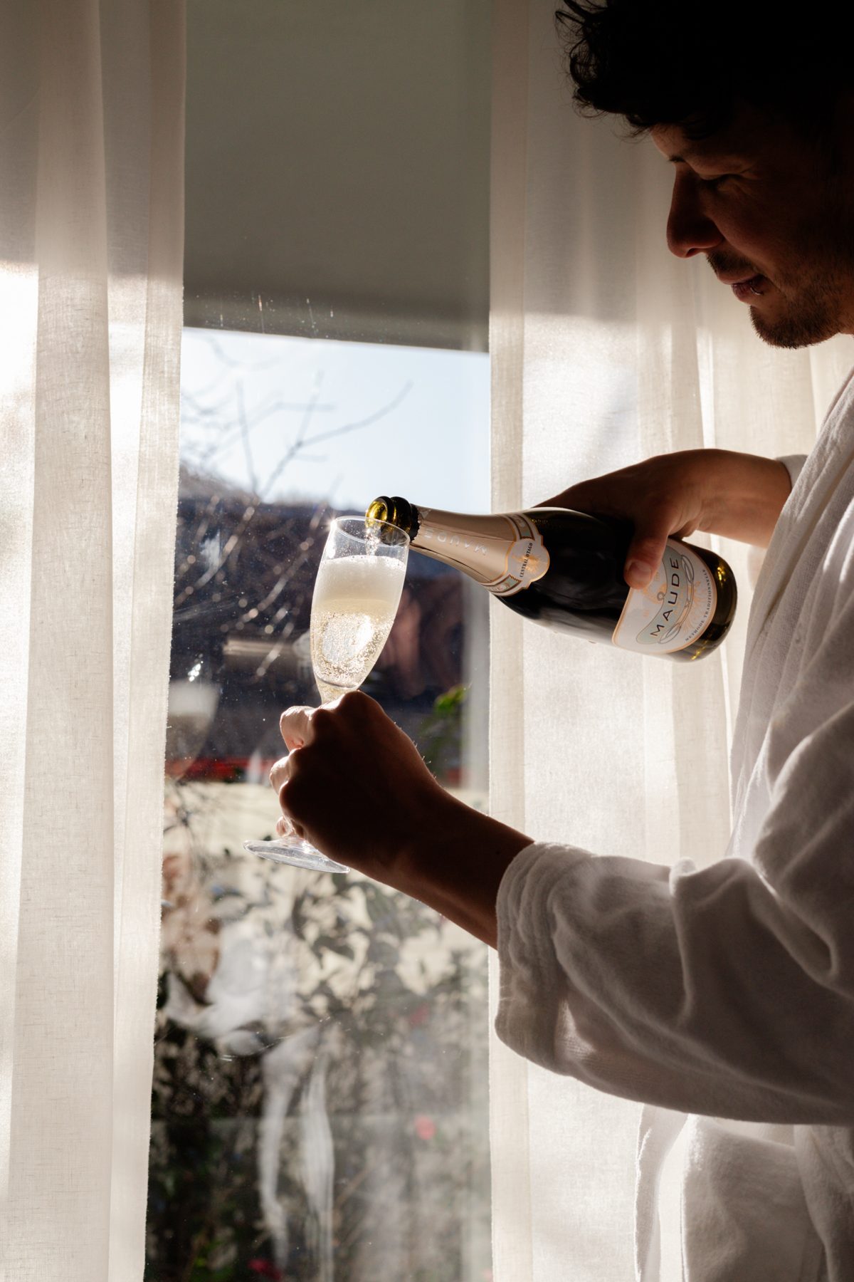 Photo: Natasha Ruiz Pouring a glass of bubbles in a suite at The Spire